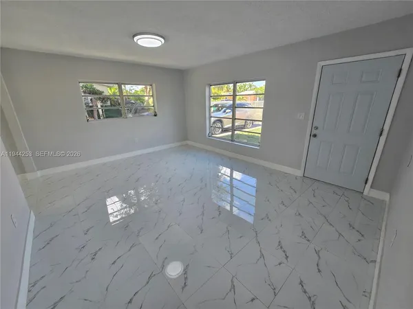 a kitchen with stainless steel appliances granite countertop a refrigerator a stove and a sink