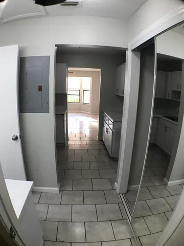 a bathroom with a sink a light fixture and a mirror