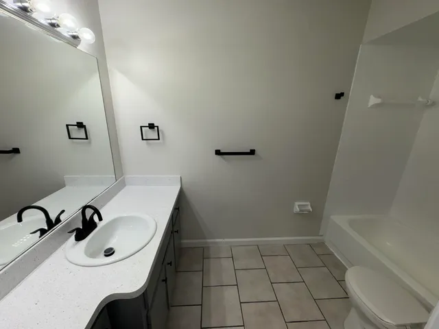 a bathroom with a sink vanity and a mirror