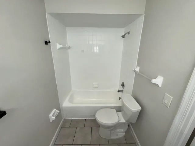 an empty room with staircase and white walls