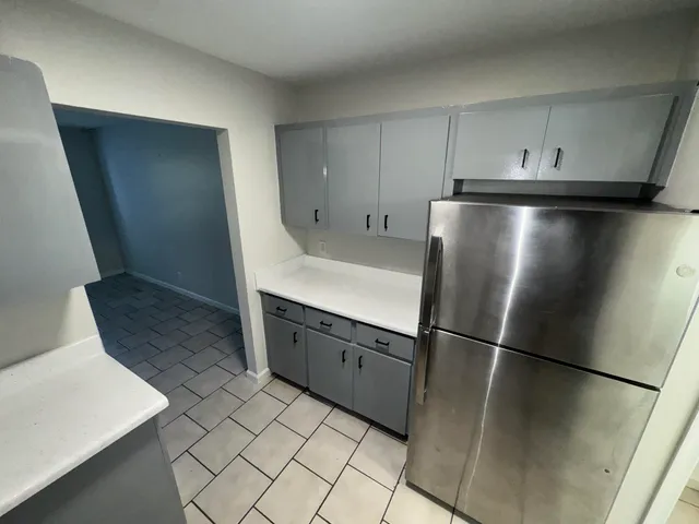 a kitchen with stainless steel appliances a refrigerator and a stove top oven