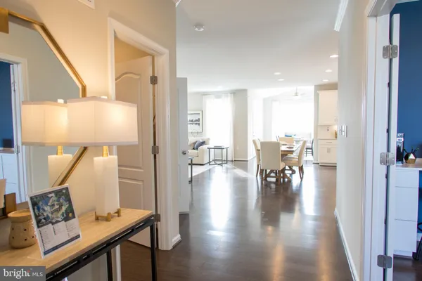 a view of a living room and dining room with wooden floor