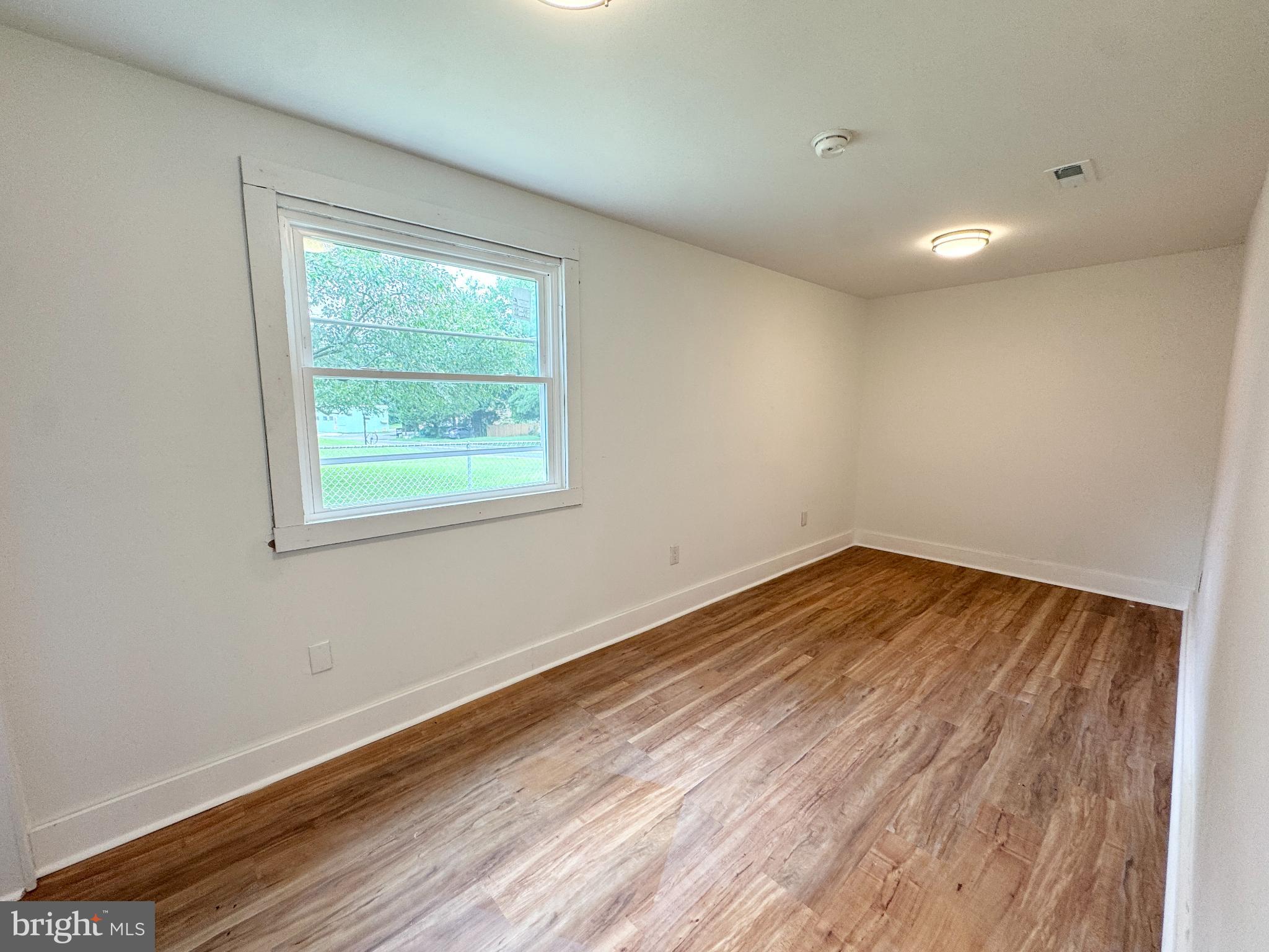 436 Halltown Road Marydel, DE 19964 - Photo 15 of 21 a view of empty room with wooden floor and fan