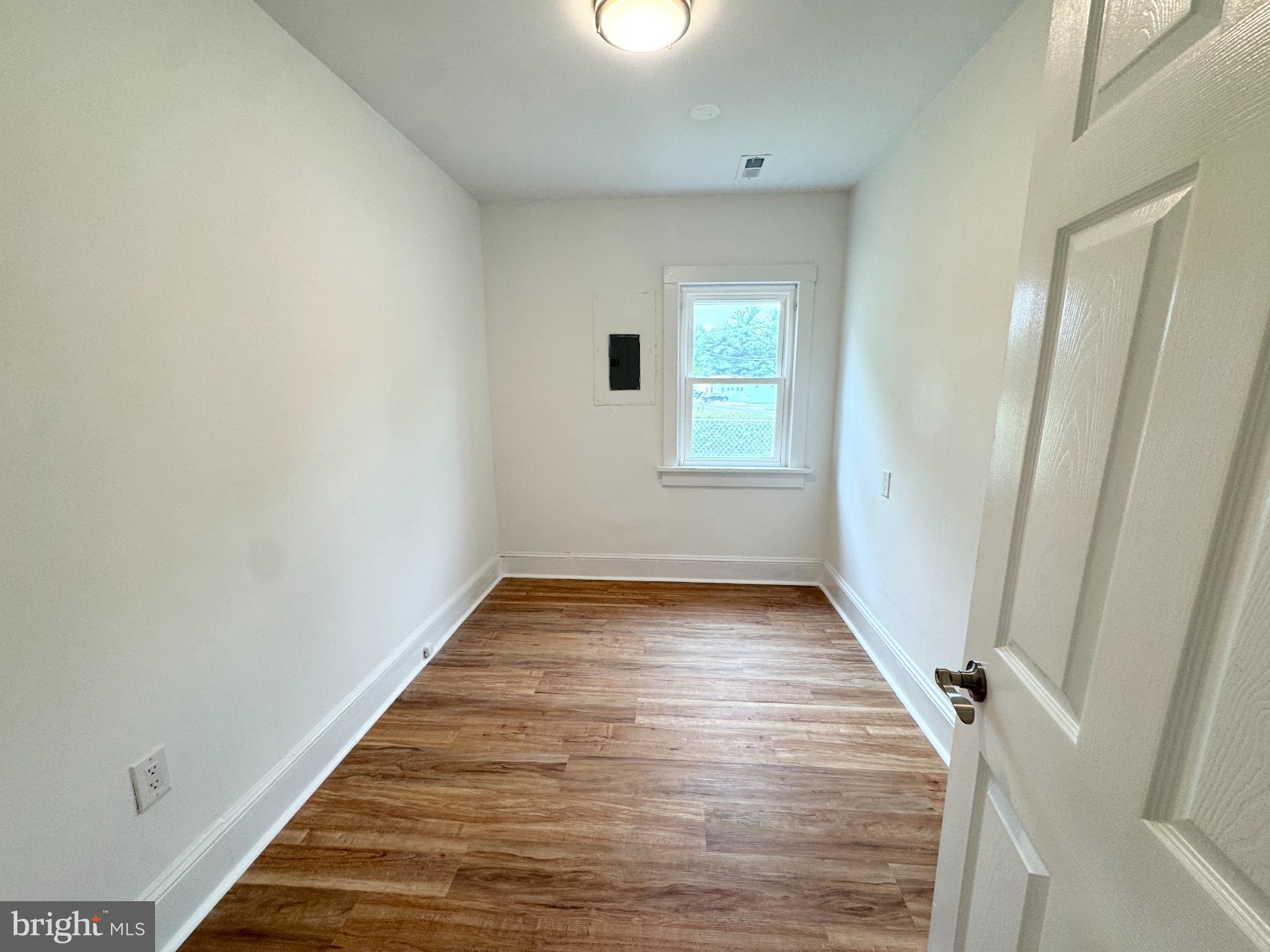 436 Halltown Road Marydel, DE 19964 - Photo 18 of 21 an empty room with wooden floor and windows