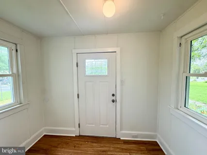 a view of room with window and wooden floor
