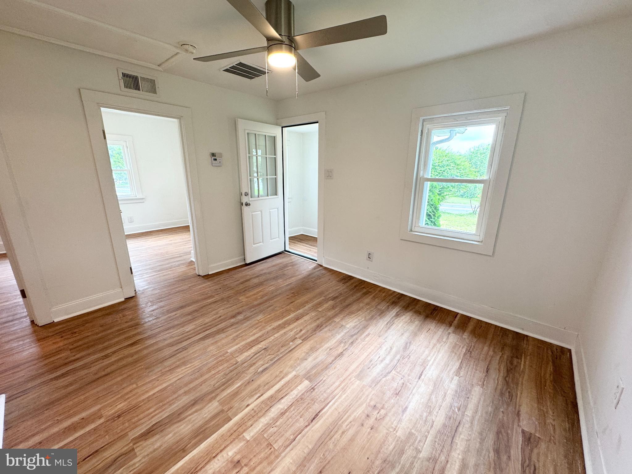 436 Halltown Road Marydel, DE 19964 - Photo 8 of 21 a view of an empty room with wooden floor and a window