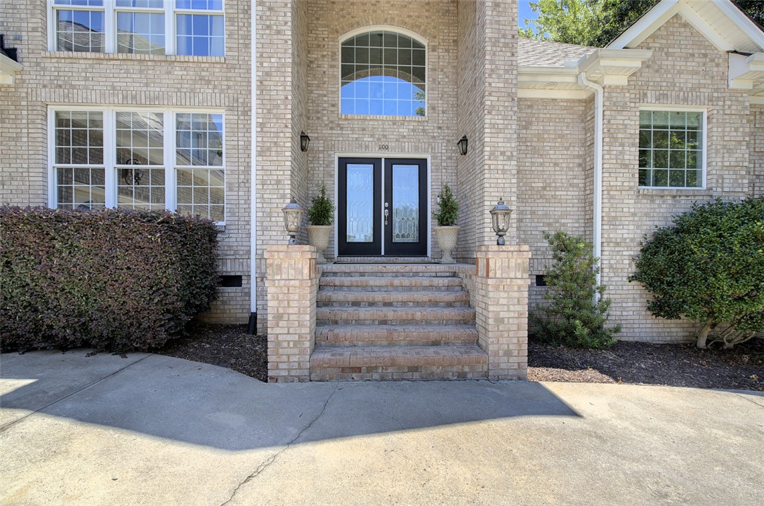 100 Turnberry Road Anderson, SC 29621 - Photo 2 of 41 A stately brick facade welcomes with a grand entrance and well-tended landscaping.