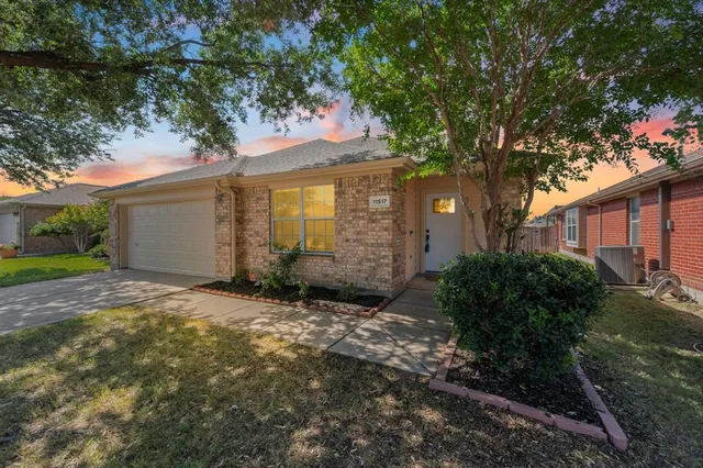 a view of a house with a tree in the background