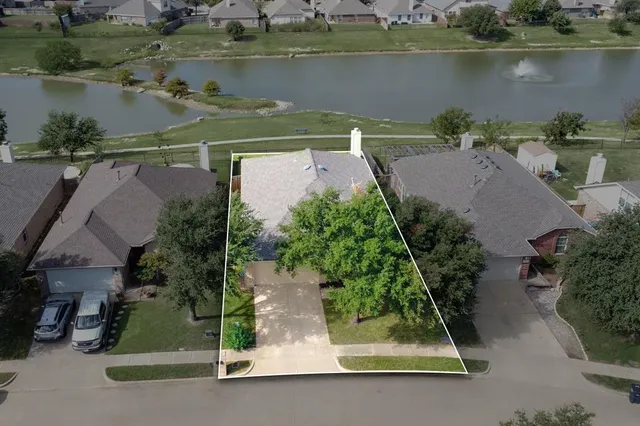 an aerial view of a house with a lake view