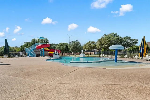 a view of a kids park with large trees