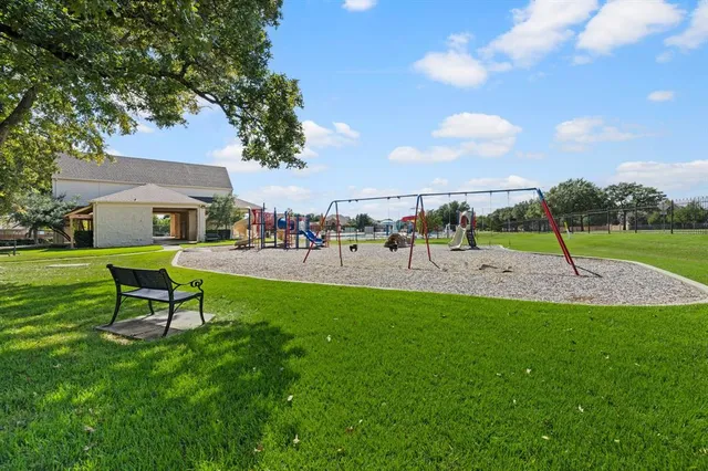 a view of a park with swings and slides