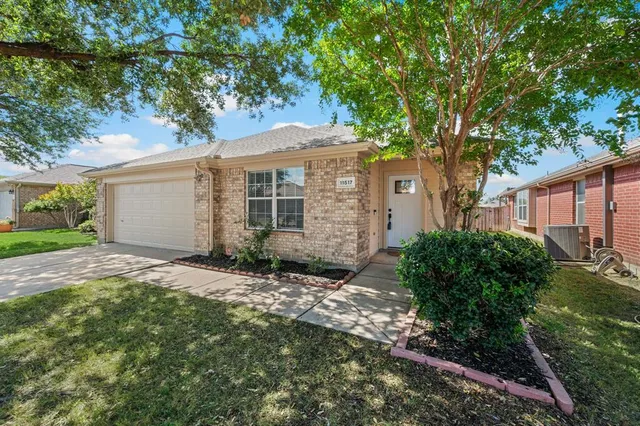 a view of a house with a tree in the yard