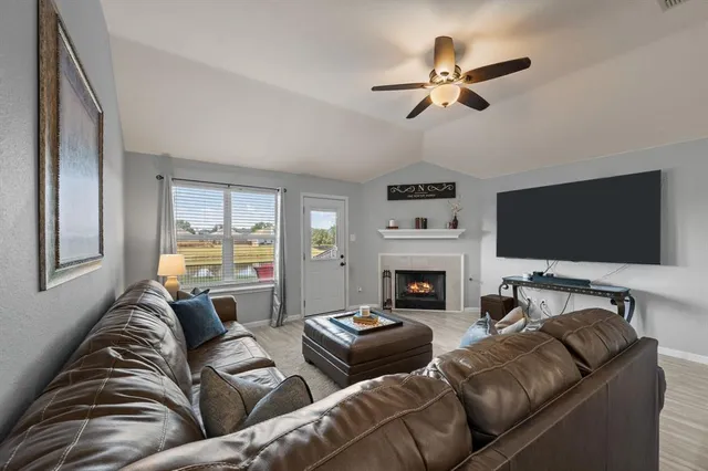 a living room with furniture and a flat screen tv