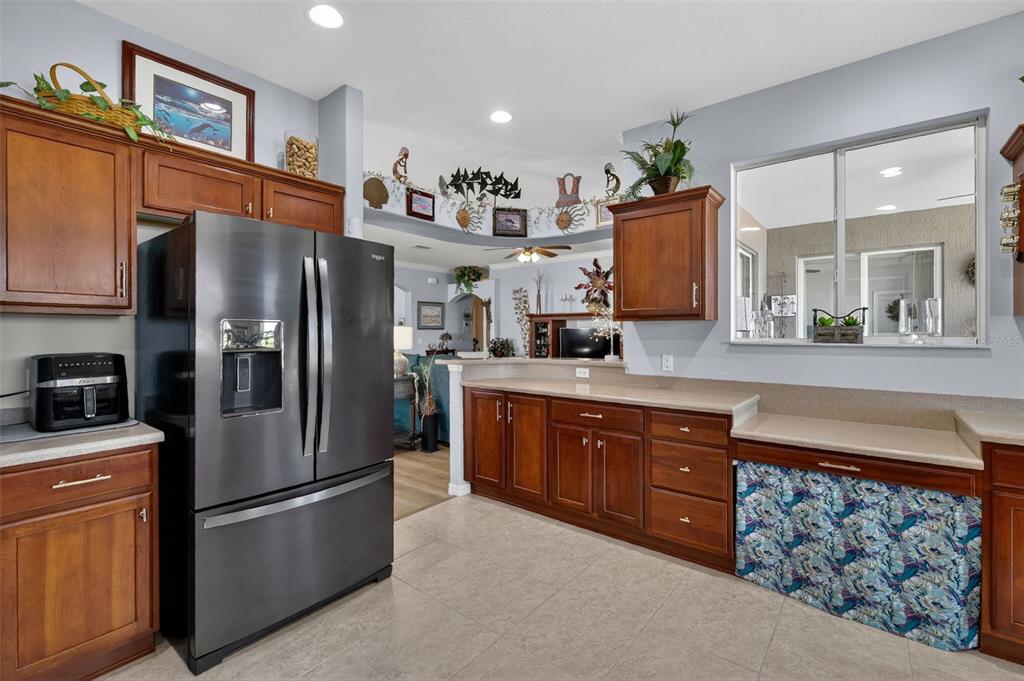 16288 Southwest 14th Avenue Road Ocala, FL 34473 - Photo 13 of 30 a kitchen with stainless steel appliances granite countertop a refrigerator a stove and a sink