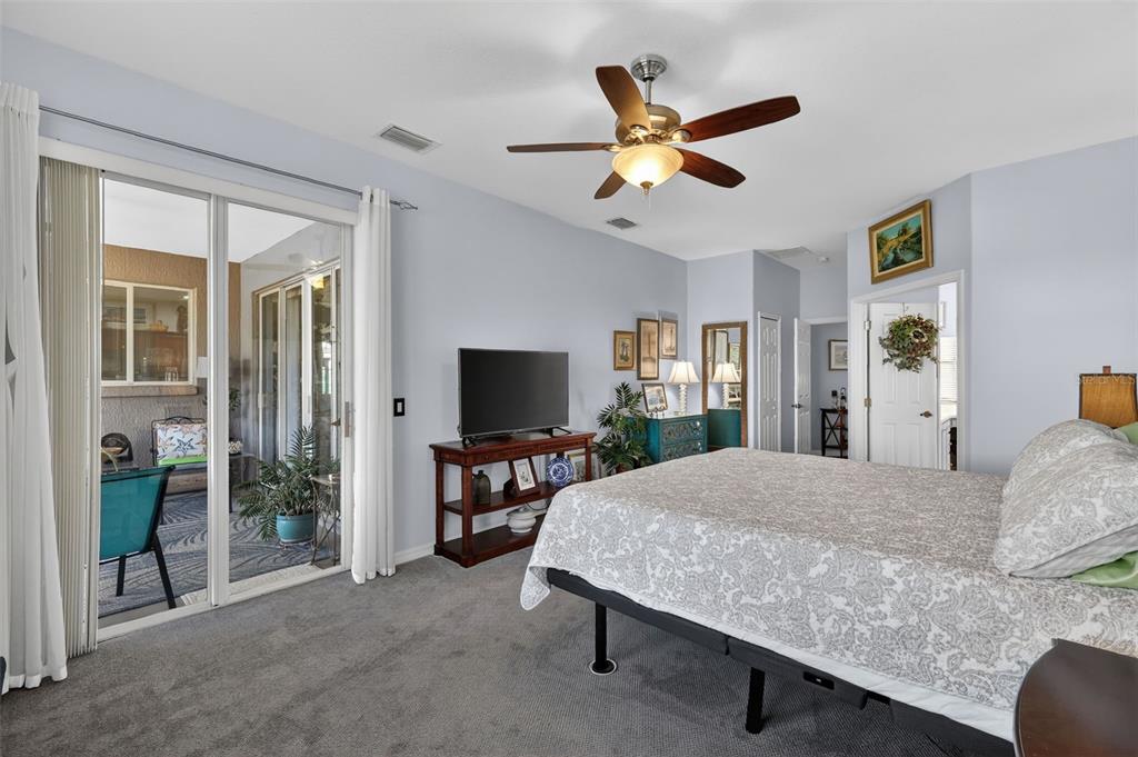 16288 Southwest 14th Avenue Road Ocala, FL 34473 - Photo 17 of 30 a bedroom with a bed and a flat screen tv