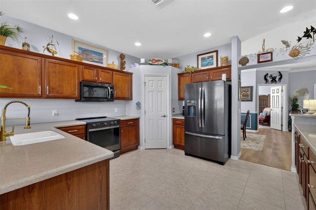 16288 Southwest 14th Avenue Road Ocala, FL 34473 - Photo 10 of 30 a kitchen with stainless steel appliances granite countertop a refrigerator stove and sink