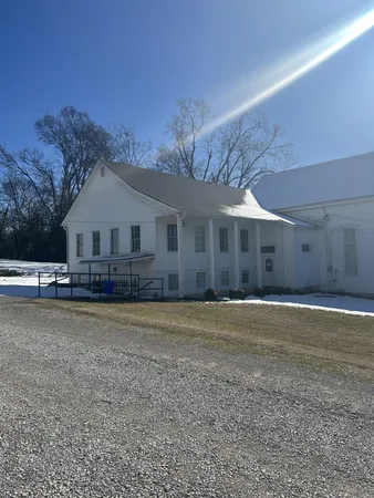 a front view of a house with a garden and deck
