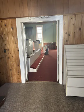 a view of a livingroom with furniture and a hallway