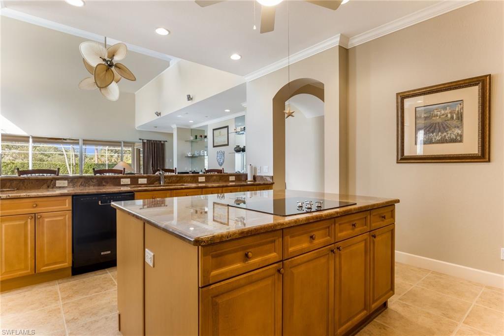 317 Steerforth Court Naples, FL 34110 - Photo 12 of 31 a kitchen with stainless steel appliances granite countertop a sink and a refrigerator
