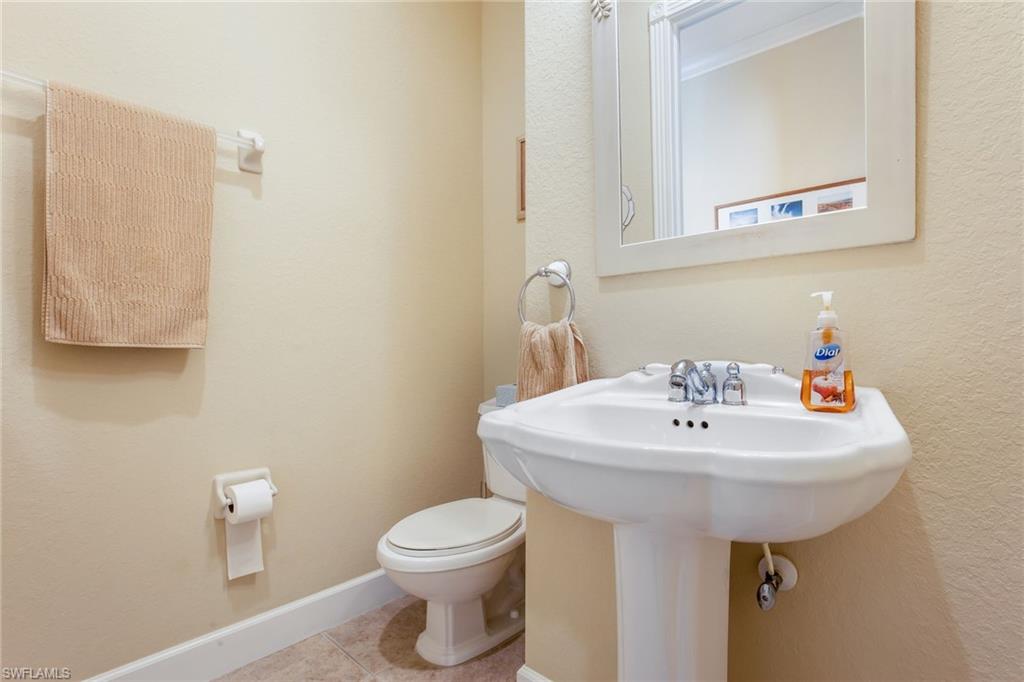 317 Steerforth Court Naples, FL 34110 - Photo 13 of 31 a bathroom with a sink a toilet and mirror