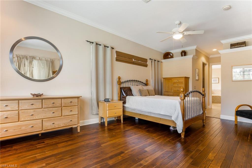 317 Steerforth Court Naples, FL 34110 - Photo 15 of 31 a spacious bedroom with a bed and a dresser