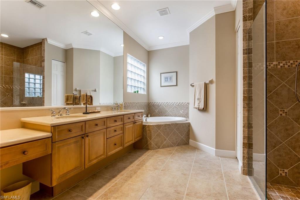 317 Steerforth Court Naples, FL 34110 - Photo 17 of 31 a large bathroom with a large tub and sink