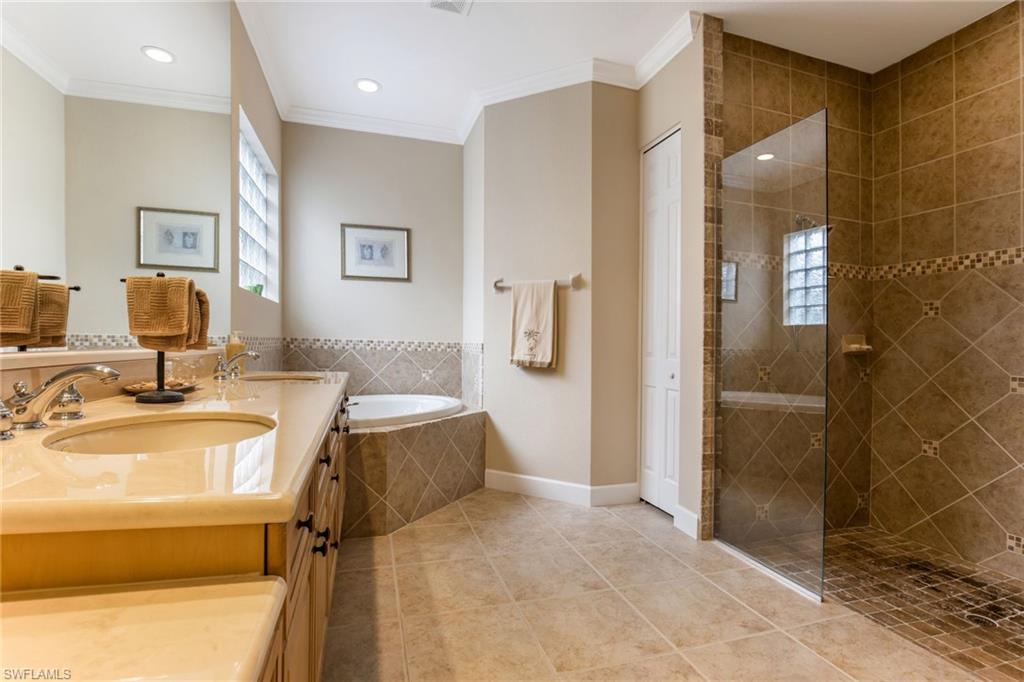 317 Steerforth Court Naples, FL 34110 - Photo 18 of 31 a bathroom with a tub sink and shower