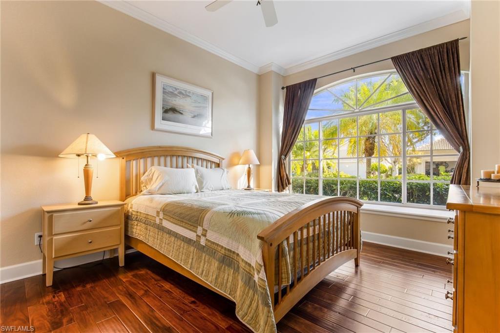 317 Steerforth Court Naples, FL 34110 - Photo 19 of 31 a bedroom with a bed and a large window