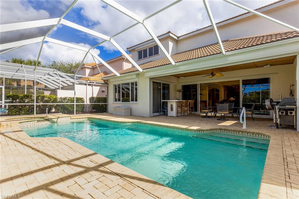 317 Steerforth Court Naples, FL 34110 - Photo 2 of 31 a view of a swimming pool with a patio