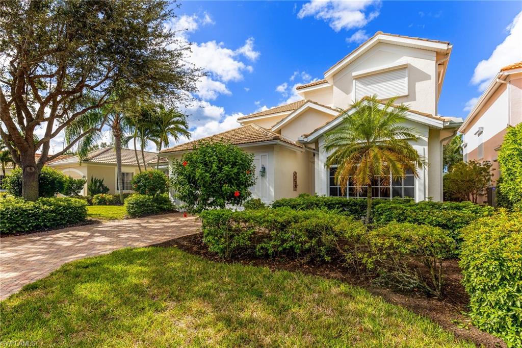 317 Steerforth Court Naples, FL 34110 - Photo 26 of 31 a view of a white house with a big yard and large trees