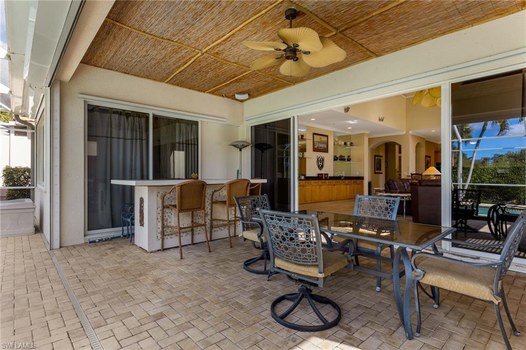 317 Steerforth Court Naples, FL 34110 - Photo 28 of 31 a living room with furniture a flat screen tv and a table