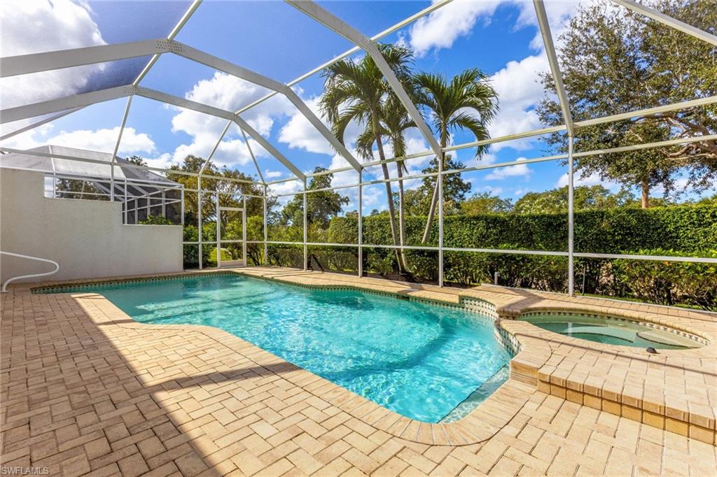 317 Steerforth Court Naples, FL 34110 - Photo 30 of 31 a view of a backyard with a swimming pool