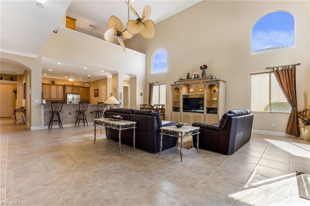 317 Steerforth Court Naples, FL 34110 - Photo 3 of 31 a living room with furniture a fireplace and a chandelier