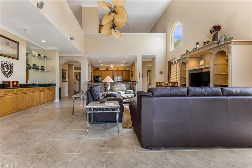 317 Steerforth Court Naples, FL 34110 - Photo 4 of 31 a living room with furniture kitchen view and a chandelier