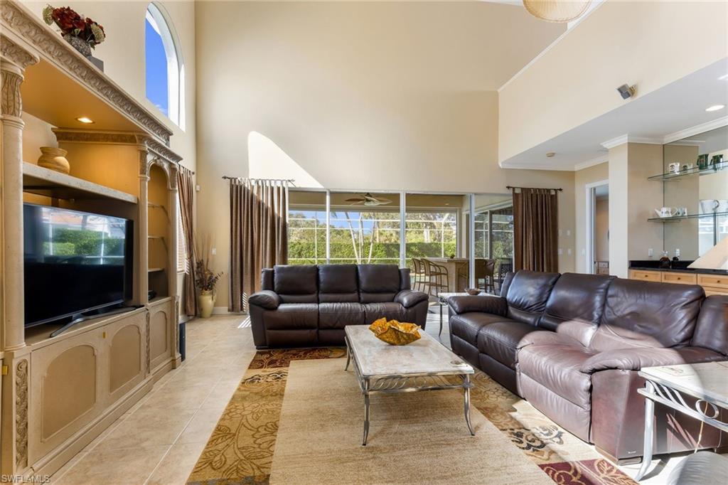 317 Steerforth Court Naples, FL 34110 - Photo 7 of 31 a living room with furniture and a flat screen tv
