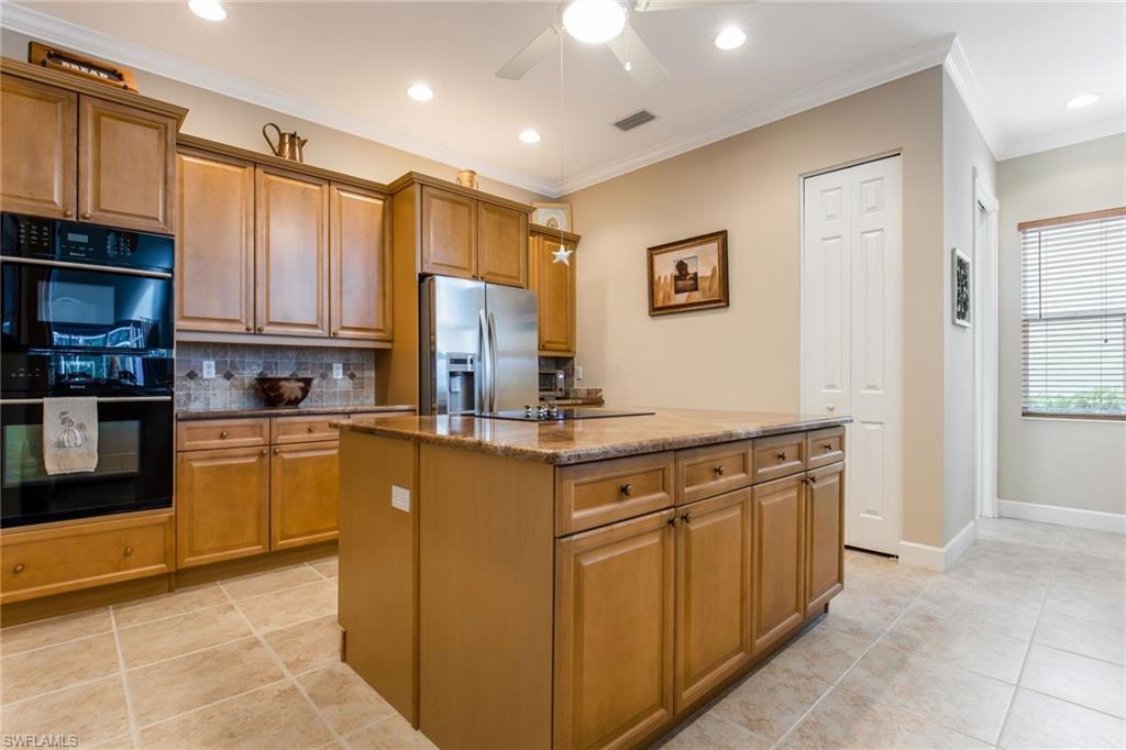 317 Steerforth Court Naples, FL 34110 - Photo 10 of 31 a kitchen with stainless steel appliances granite countertop a stove top oven a sink and dishwasher