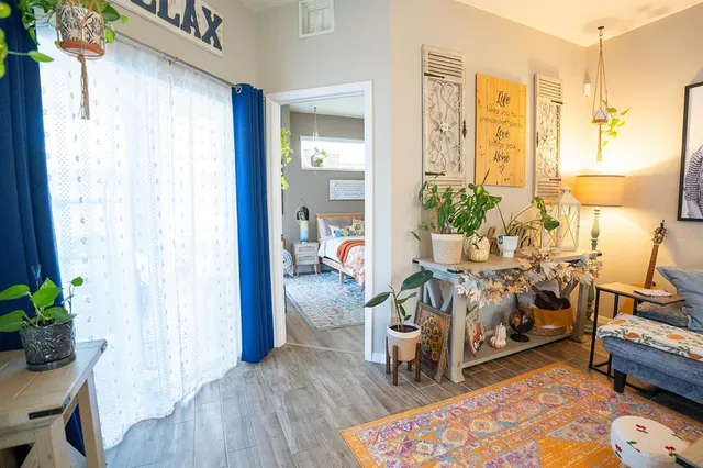 a living room with furniture and a wooden floor