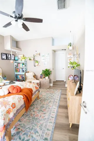 a bedroom with a bed and a flat tv screen on a dresser