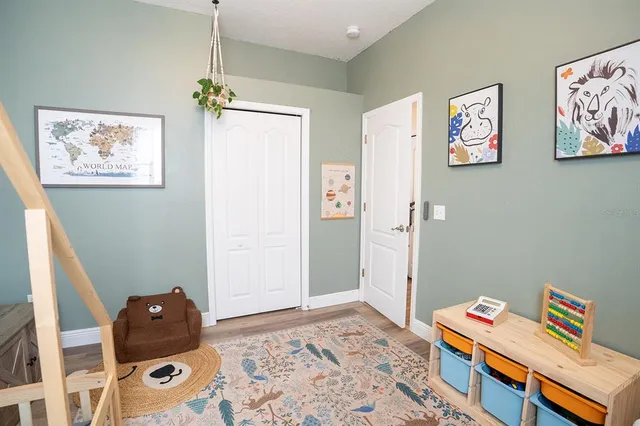 a living room with furniture a rug and a large window