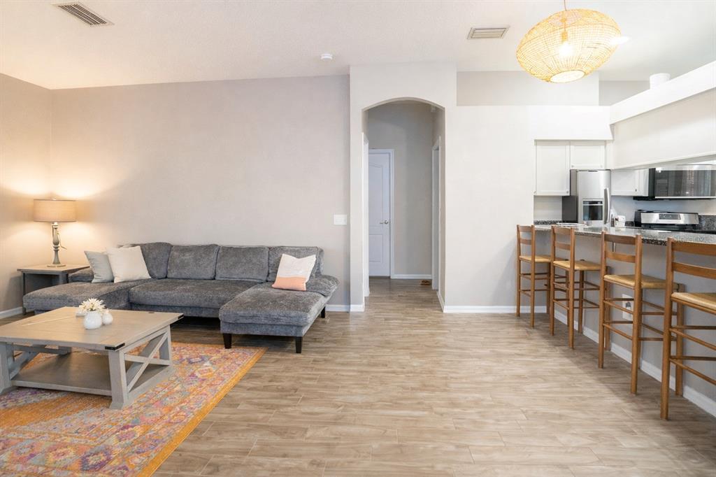 6207 Kiteridge Drive Lithia, FL 33547 - Photo 6 of 25 a living room with furniture and a dining table with wooden floor