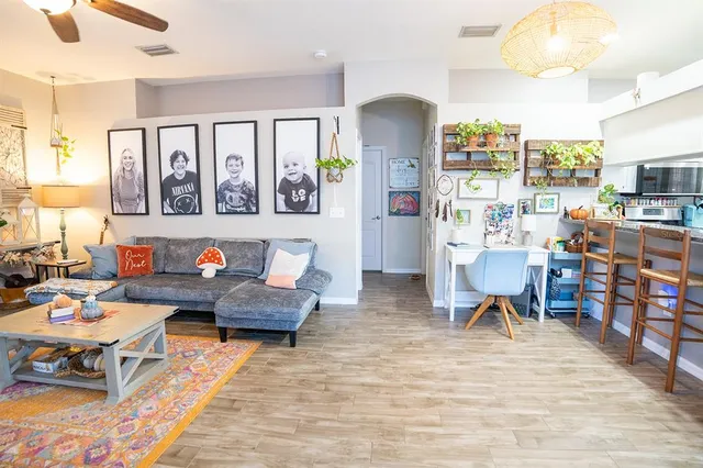 a living room with furniture and wooden floor