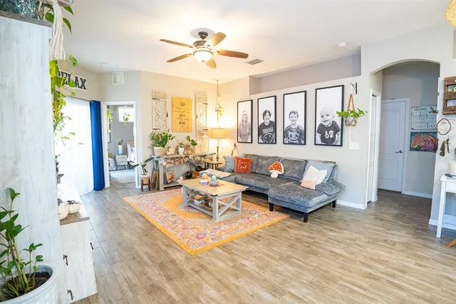 a living room with furniture and a chandelier