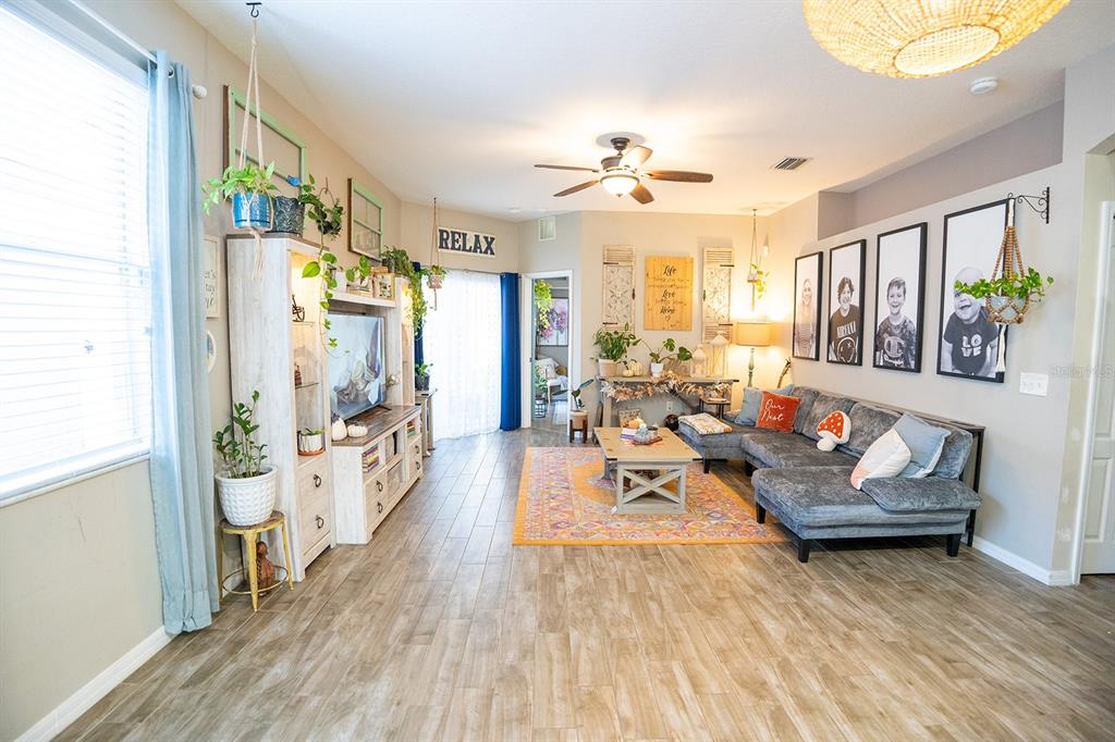 6207 Kiteridge Drive Lithia, FL 33547 - Photo 9 of 39 a living room with furniture and a chandelier