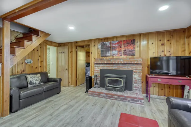 a kitchen with stainless steel appliances granite countertop a refrigerator a stove top oven a sink dishwasher and wooden cabinets with wooden floor