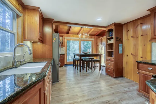 a kitchen with granite countertop a sink and a refrigerator