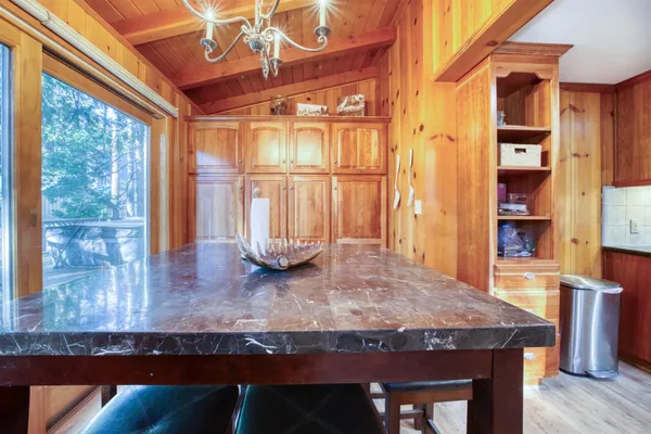 a kitchen with a table chairs and wooden floor