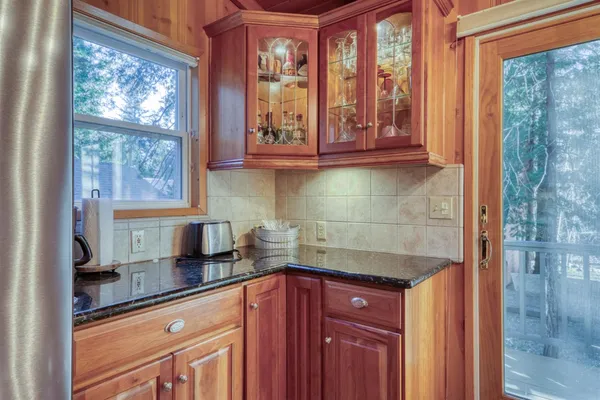 a kitchen with granite countertop a sink and a window