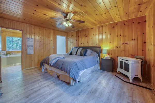 a spacious bedroom with a bed and a table