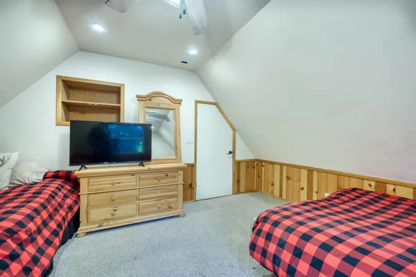 a spacious bedroom with a bed and a table in it