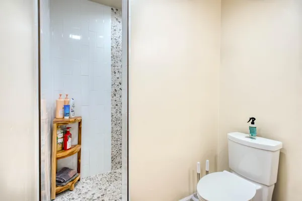 a view of a house with a yard plants and wooden fence
